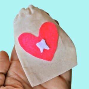 hand holding small Tooth Fairy bag