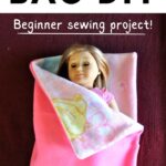 American girl doll inside pink fabric sleeping bag