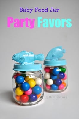 two glass jars with gumboils inside and blue fish on top