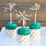 cupcake toppers made from tissue paper on colorful cupcakes