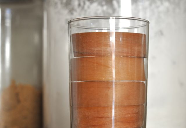 Popsicle sticks bent in a glass