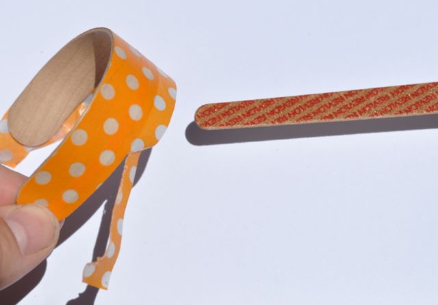 Sand the edges of the popsicle stick bracelet