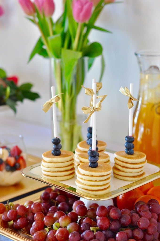 Mini pancakes on a stick for a brunch party. Cute idea!