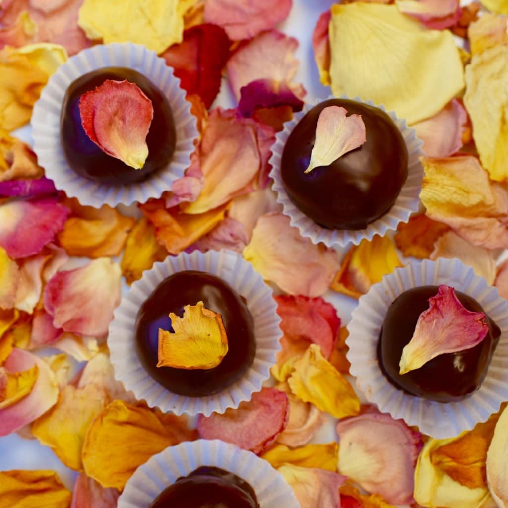 Edible rose petal flowers on chocolate truffles