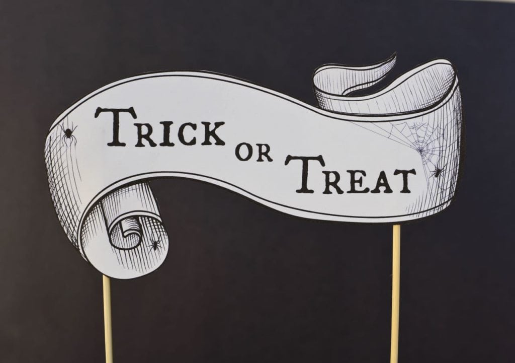 Halloween sign with trick or treat words on it