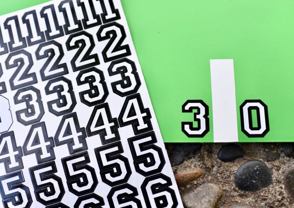 Add stickers to the DIY football toss game for kids