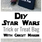 black Star Wars trick or treat bag next to Jedi boy