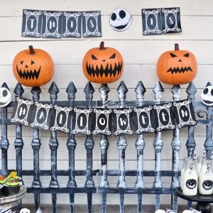 Nightmare Before Christmas Halloween party pumpkins on cemetery fence