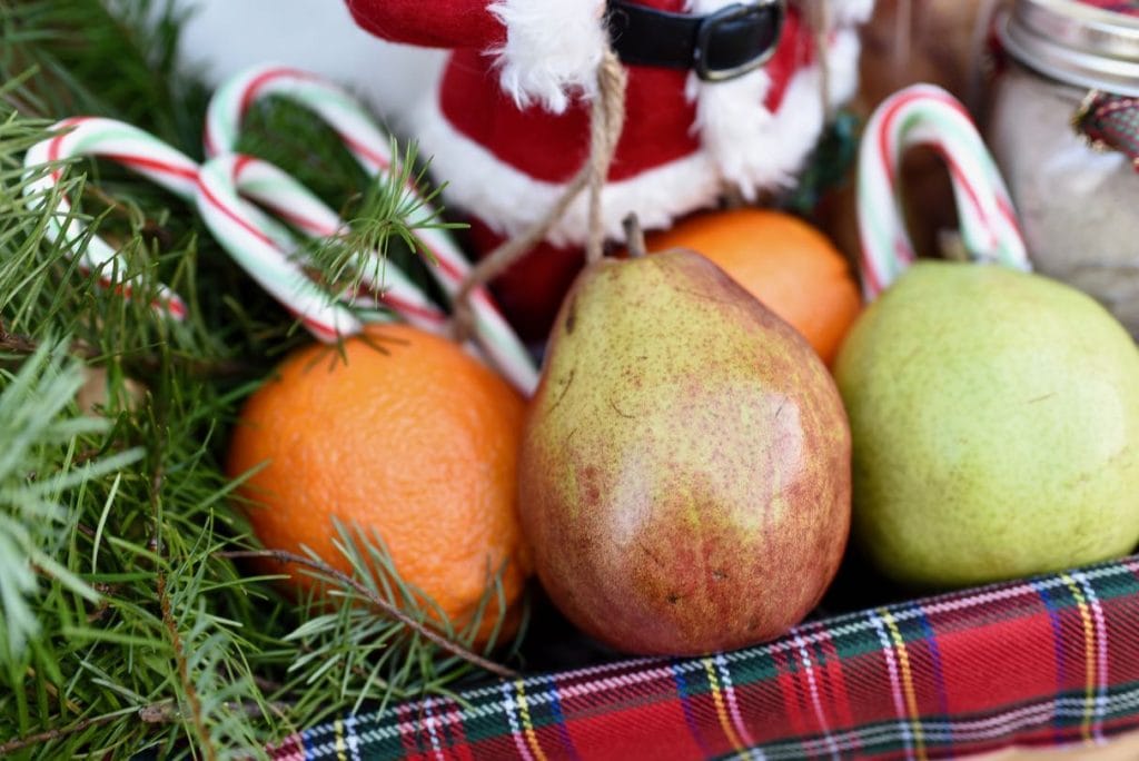 holiday pears and candy canes inside red plaid lined basket