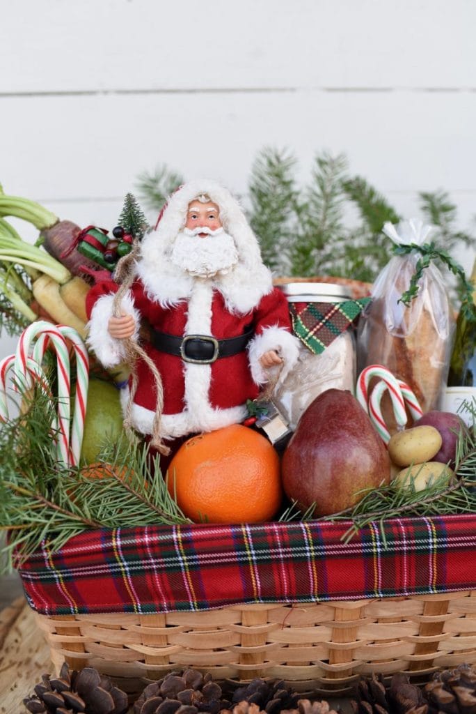 Santa decoration and food inside Christmas gift basket