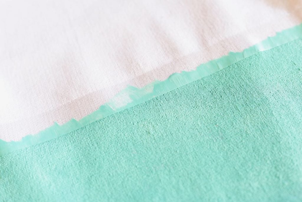 Painting the DIY beach bag with turquoise paint