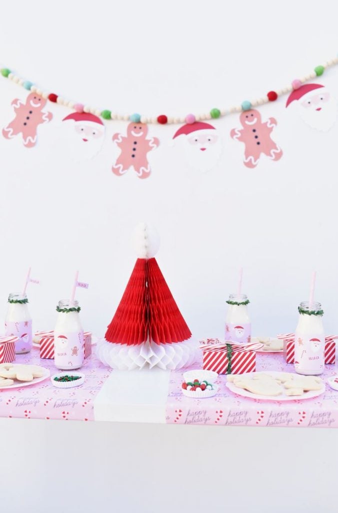 Plan the ultimate Christmas cookie decorating party with these tips + FREE printables! Get free printable cookie party invitations, bottle wraps, favor tags, and garland.