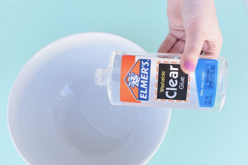 Clear glue pouring into white bowl