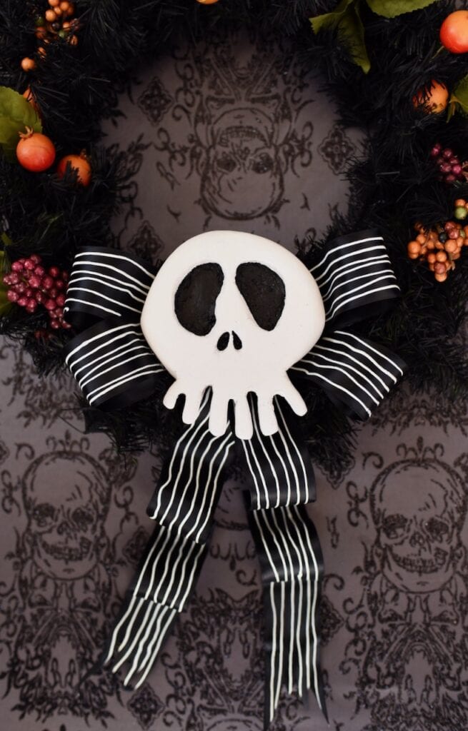 white Jack Skellington skull with black bow on wreath