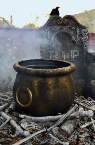 Painted witch cauldron and fake fire prop for Halloween