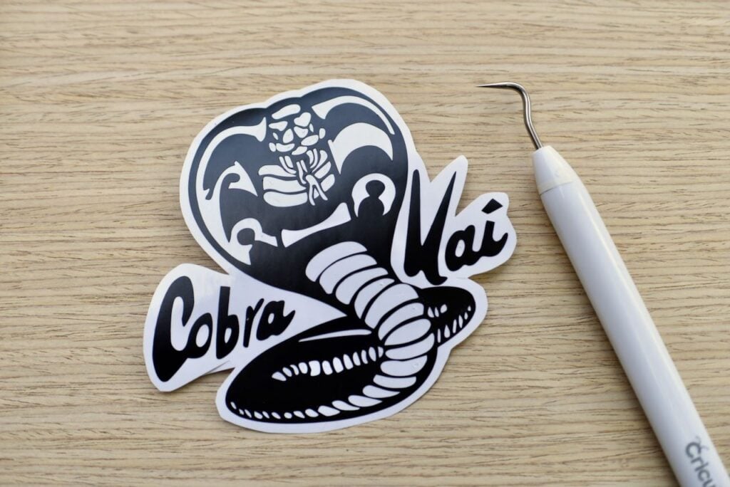 Cricut weeding tool with black Cobra Kai logo