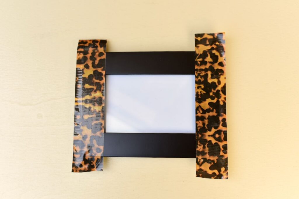 two pieces of duck tape on picture frame