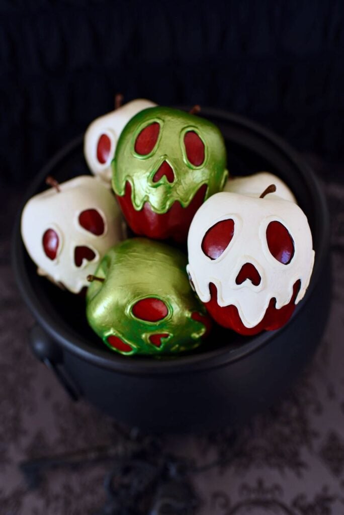 cauldron with green and white poison apples