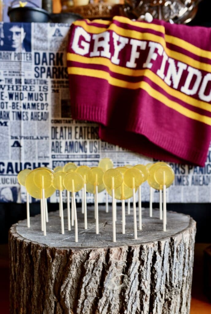 yellow butterbeer lollipops in tree stump lollipop stand