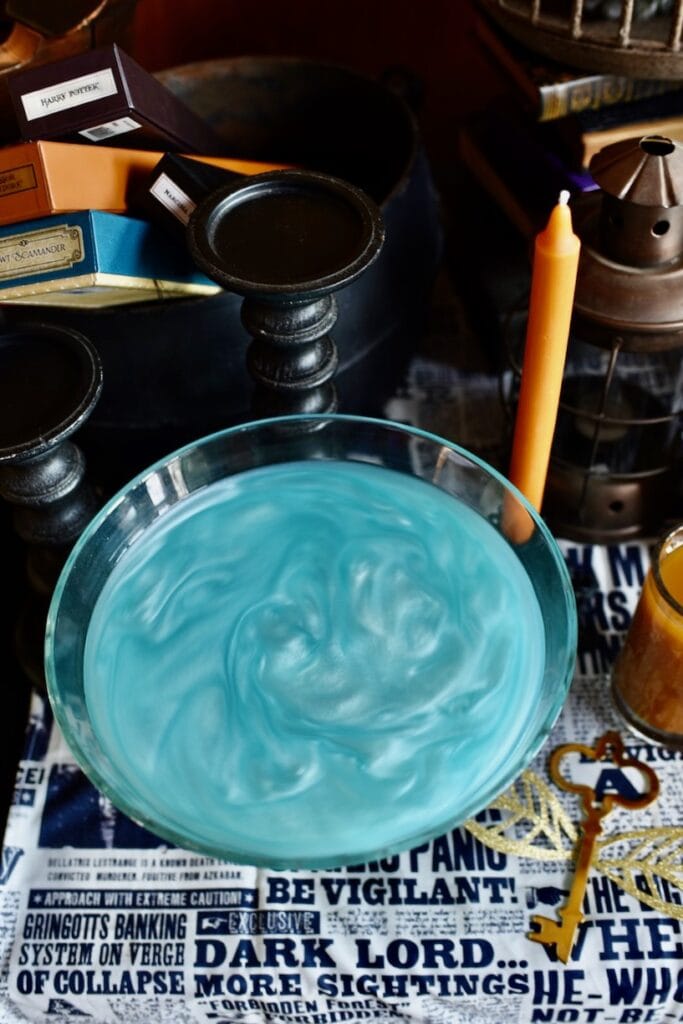 swirling shimmery blue drink in clear bowl