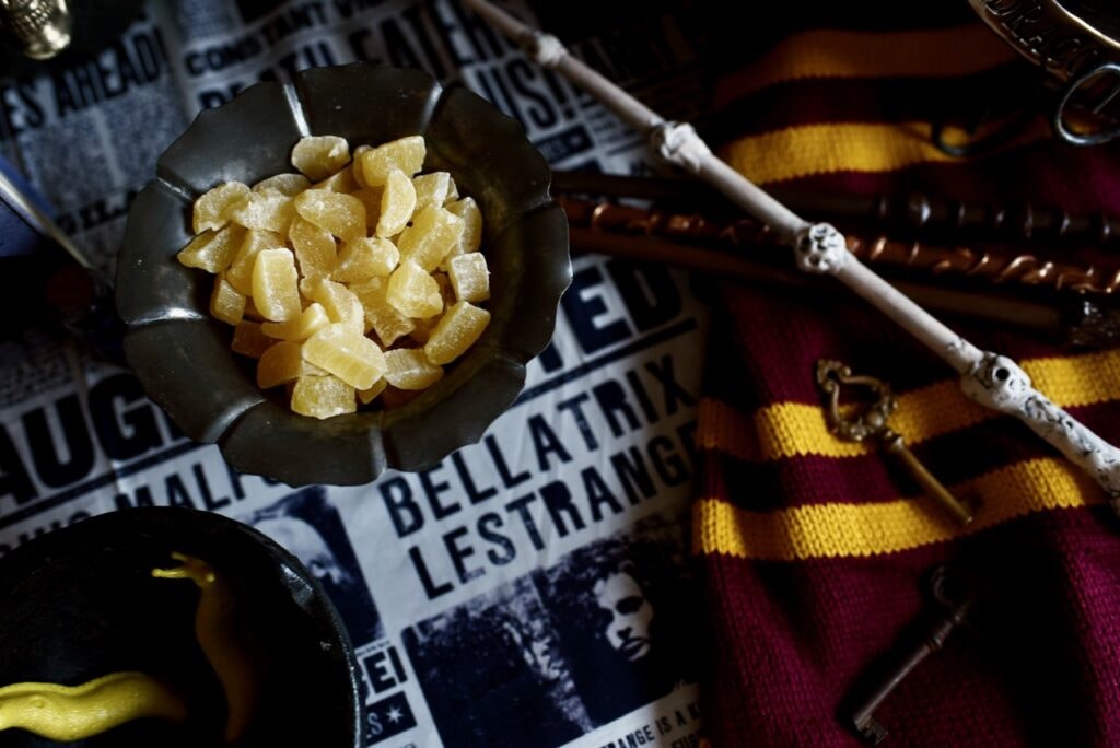 candied pineapple in metal dish near wand