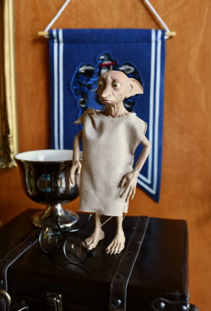Dobby statue next to metal dish