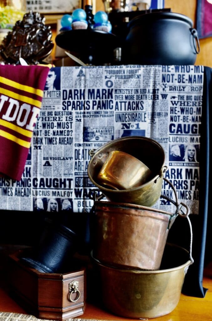 stacked brass cauldrons in front of decorated table