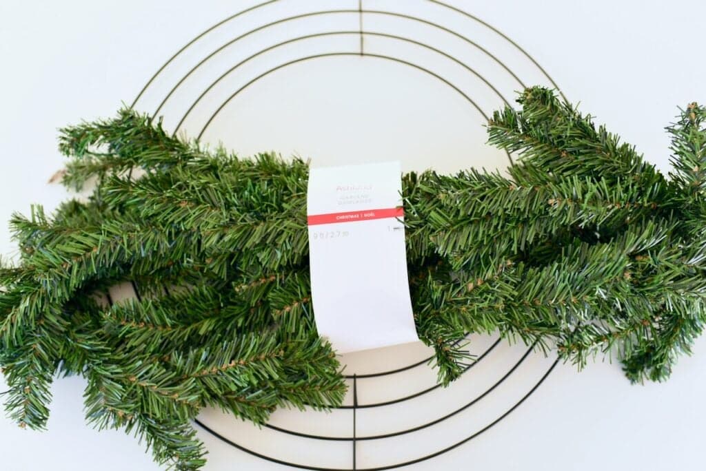 wrapped greenery garland on wire wreath form