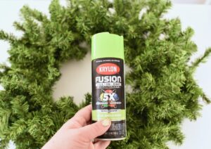 green spray paint can next to green wreath