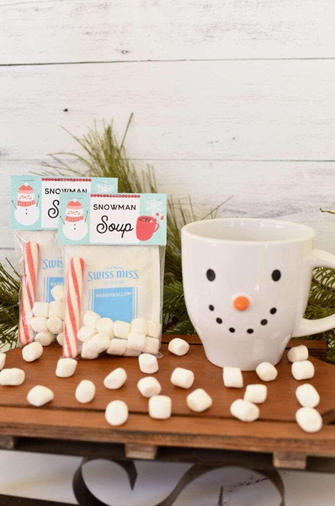 snowman soup ingredients on brown sled with snowman mug