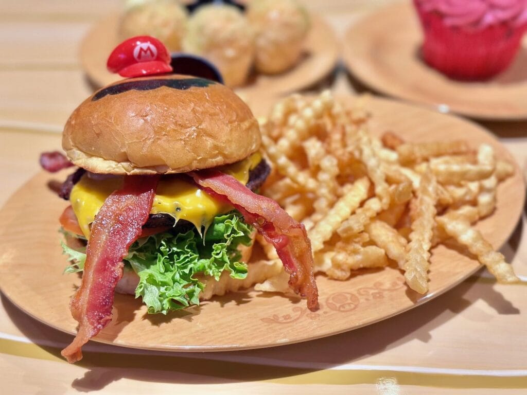 cheeseburger with bacon, lettuce, cheese, and French fries