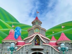 gray princess castle with green hills and blue sky