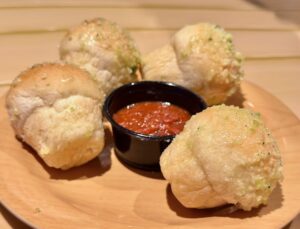 rolls on plate with garlic and butter with red dipping sauce