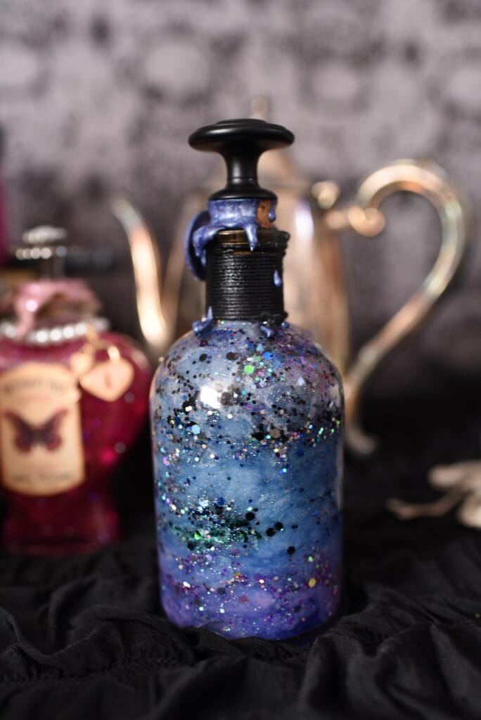 Glittery purple and blue galaxy jar inside glass bottle