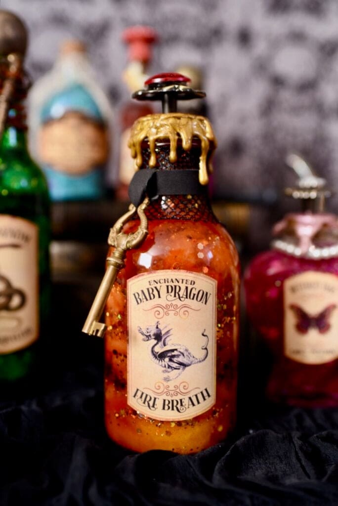 Dragon fire breath potion bottle with orange liquid and gold glitter inside