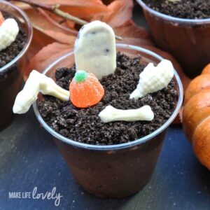 chocolate crumbles in cup with white chocolate bones