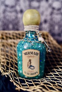 Sparkly blue liquid in mermaid tears potion bottle