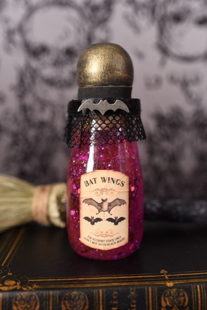 bright pink bat wings potion with label in glass bottle