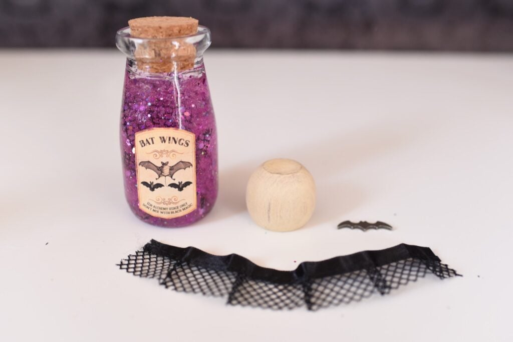 black tulle material next to pink liquid in glass bottle