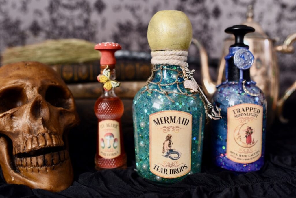 three bottle potions in glass bottles with lids