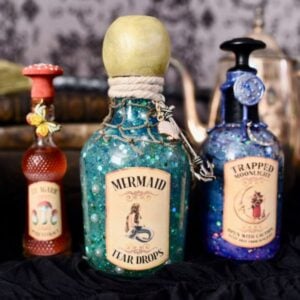 three potion bottles in glass jars with Halloween labels