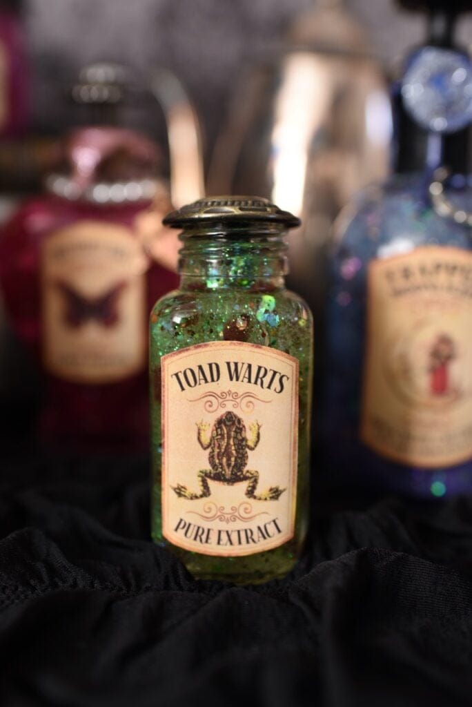 green toad arts potion in glass bottle with frog label