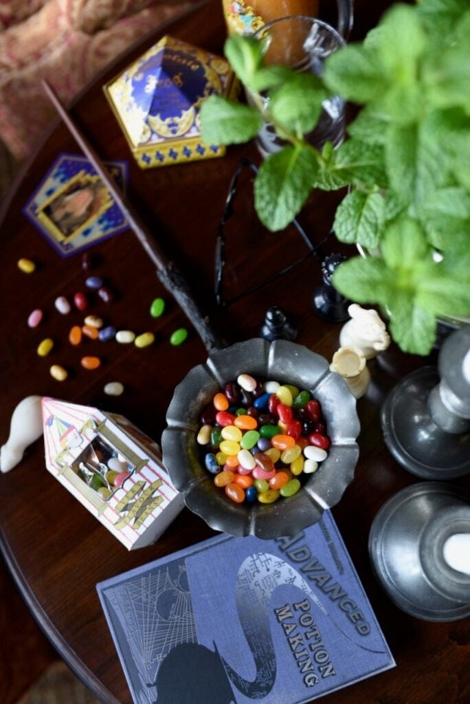Bertie Botts every flavor jelly beans next to purple advanced potions book
