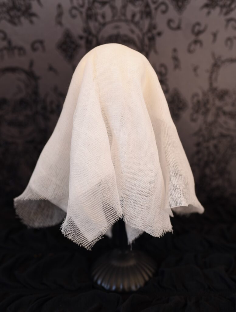 cheesecloth ghost on black tablecloth