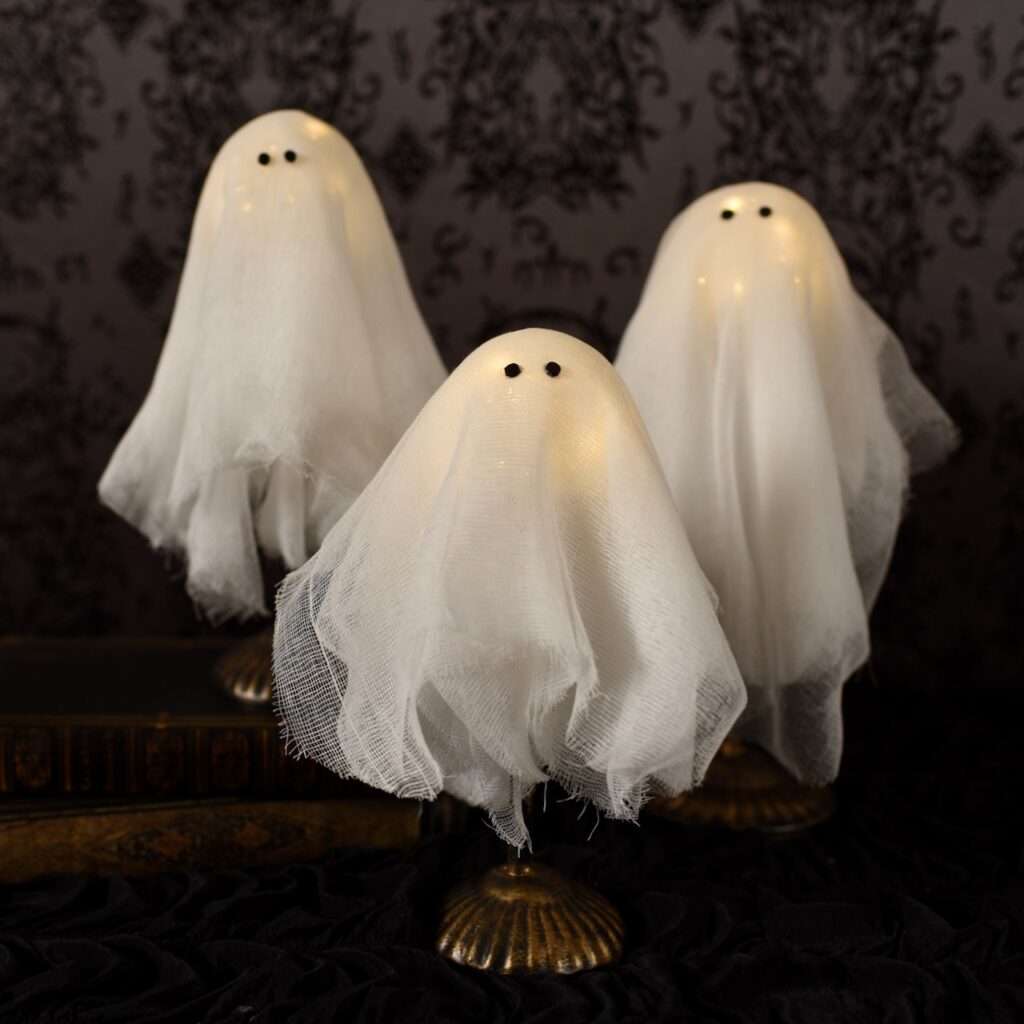 three white light up ghosts