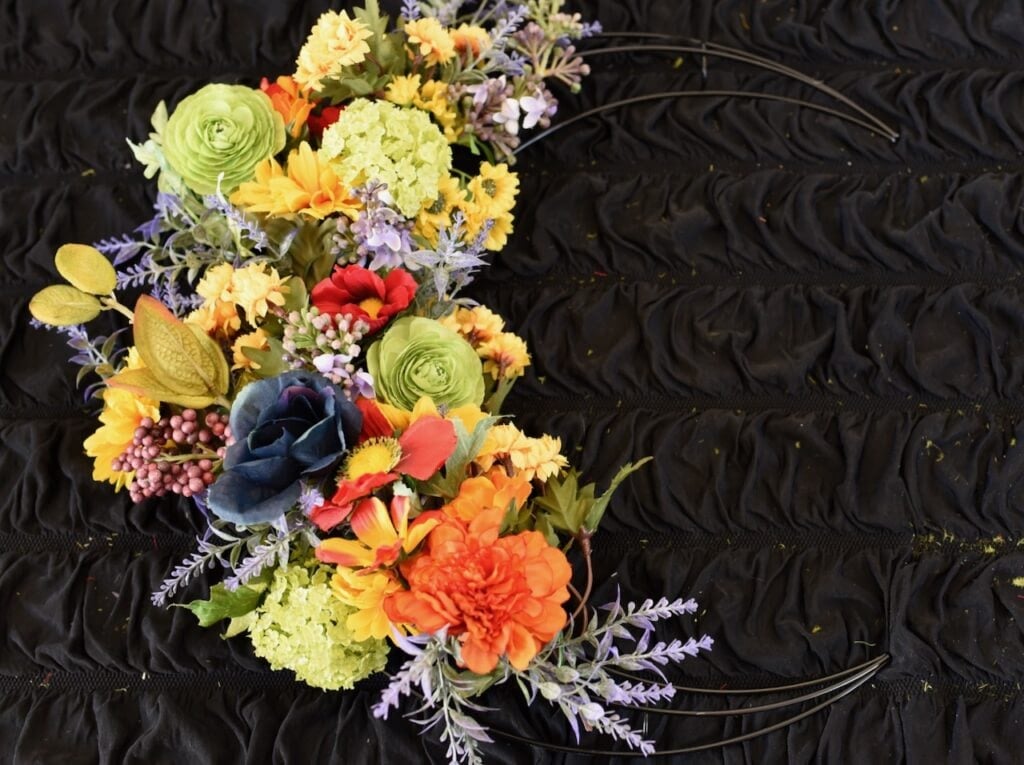 moon wreath with colorful flowers on it