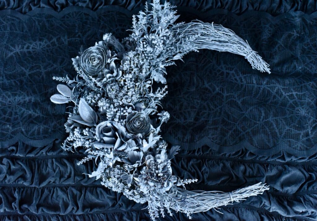 gray floral moon wreath on black background