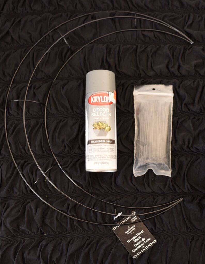 metal moon wreath form next to gray spray paint can