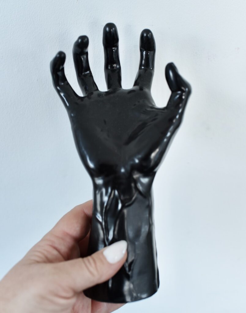 hand holding black fake hand