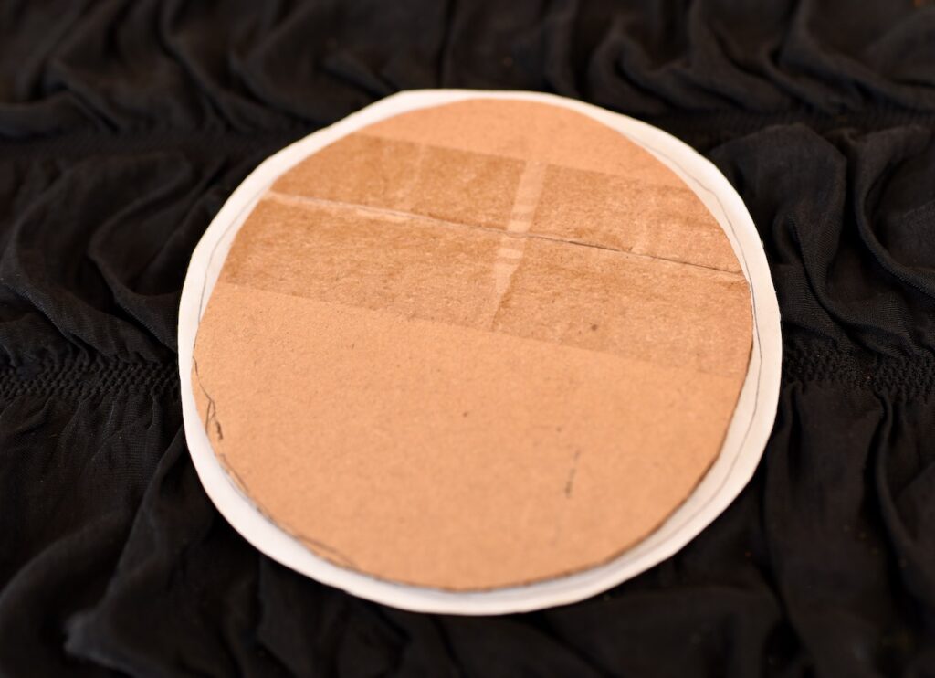 round piece of cardboard with felt on it